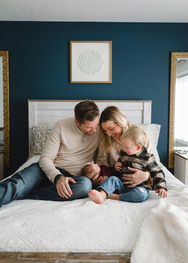 Family sitting together on a bed